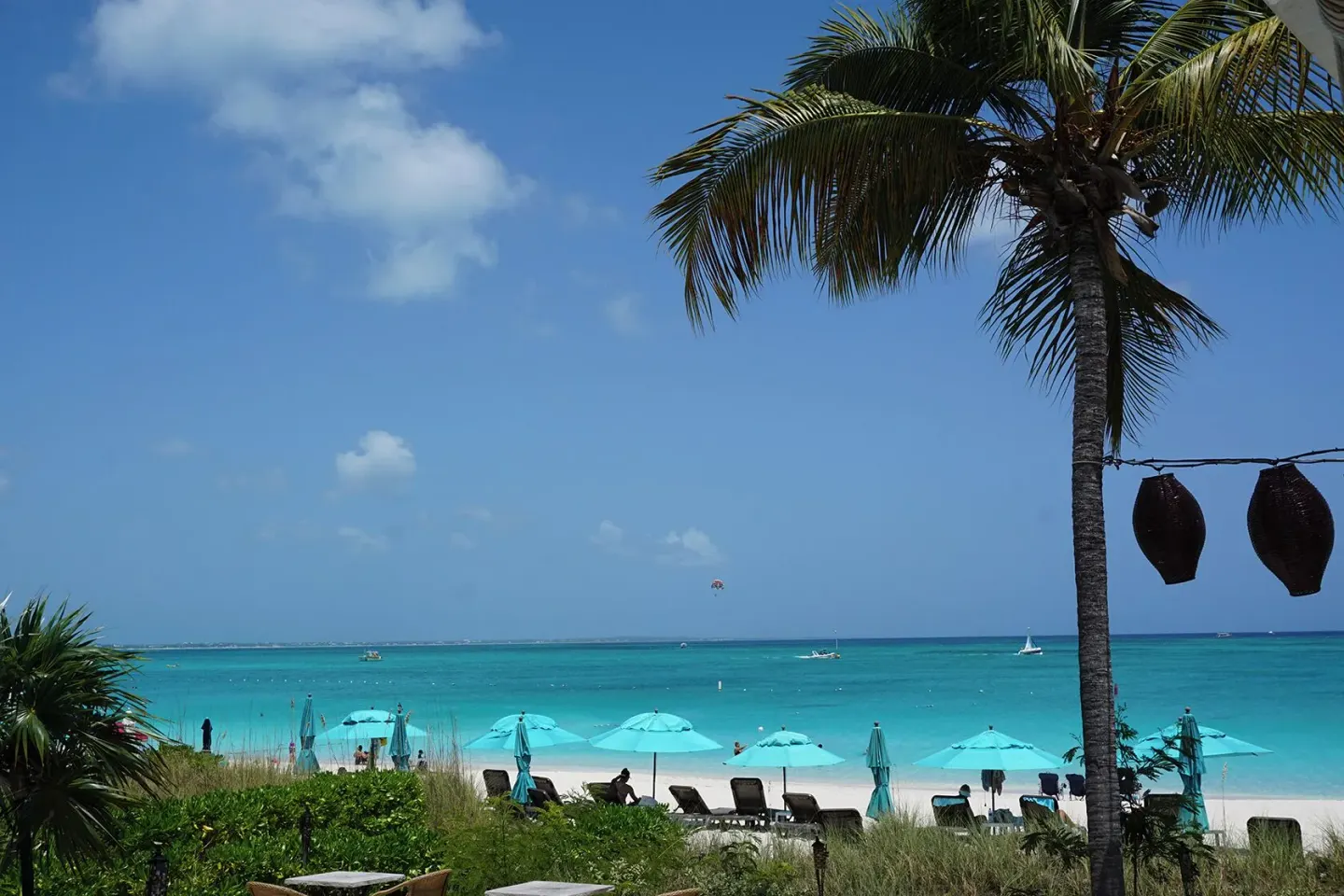 Palm-framed beach view with turquoise water at Sibonné Beach Hotel.