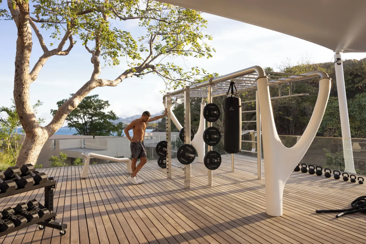 An open-air fitness deck with weights and a punching bag at Silversands Beach House Grenada.