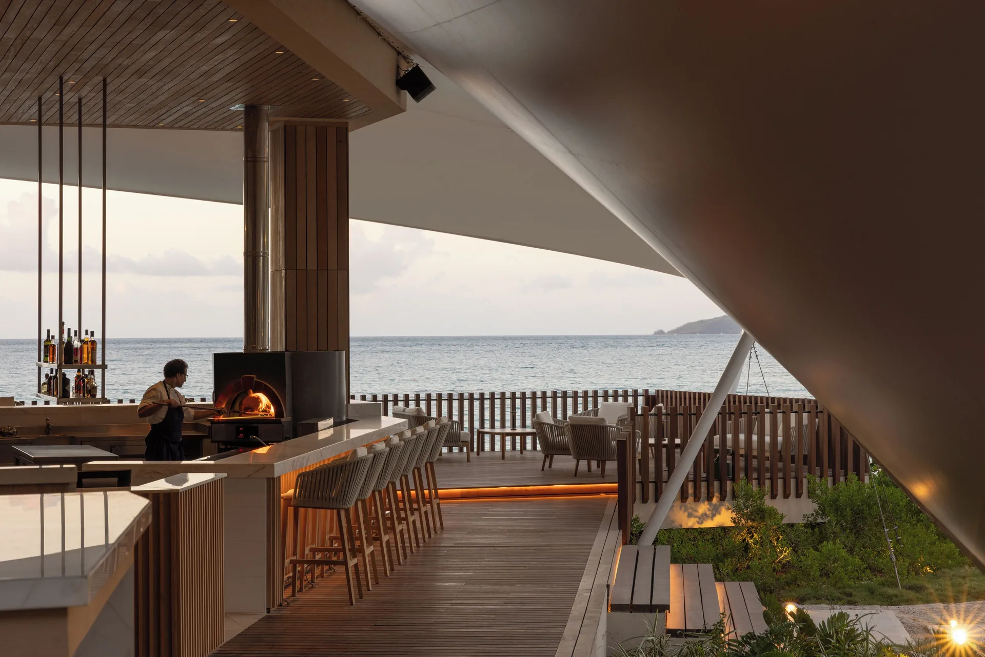 Oceanfront bar with pizza oven and terrace seating at Silversands Beach House Grenada.