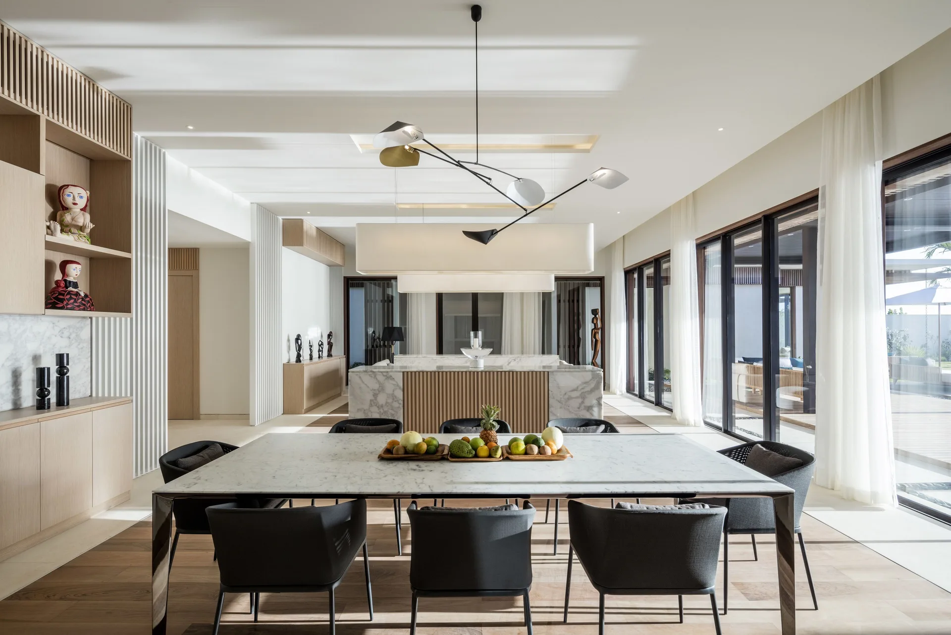 Villa dining table and open kitchen at Silversands Beach House Grenada.