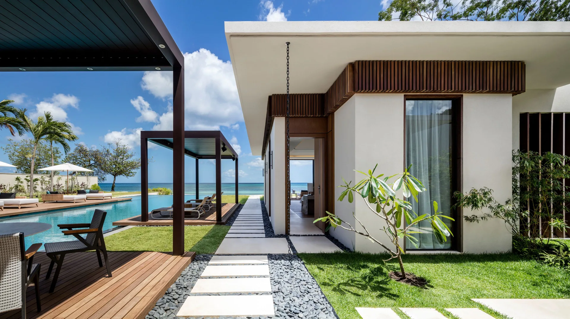 Beachfront villa exterior with pool and garden path at Silversands Beach House Grenada.