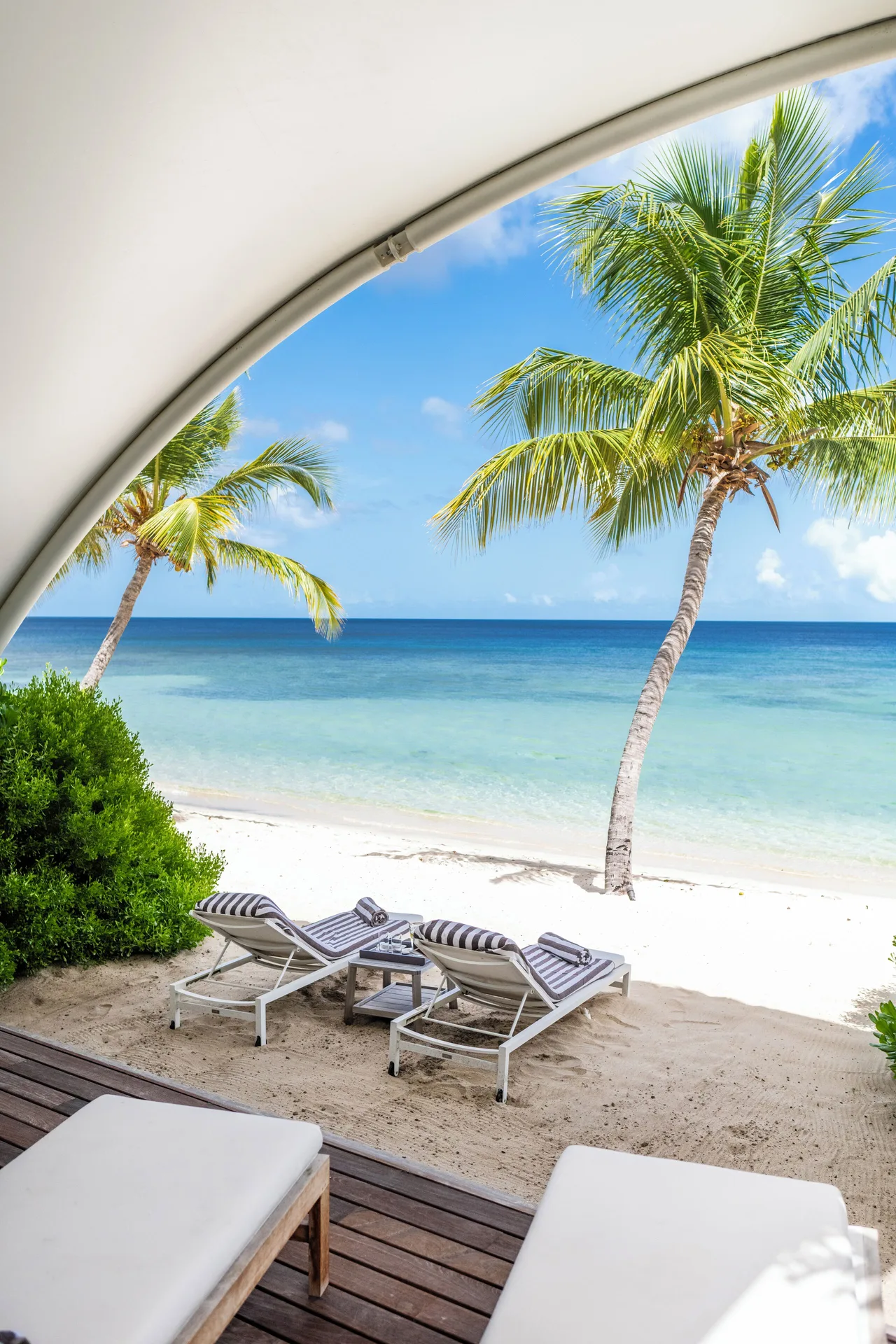 Beachfront Bungalow beach loungers and sea at Silversands Beach House Grenada.