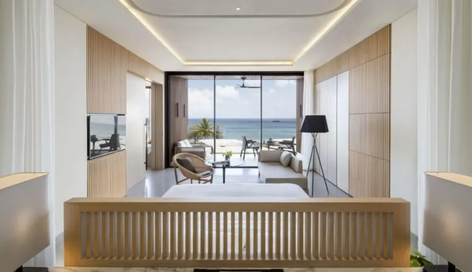 Ocean View Room with king bed, seating area, balcony and sea view at Silversands Beach House Grenada.