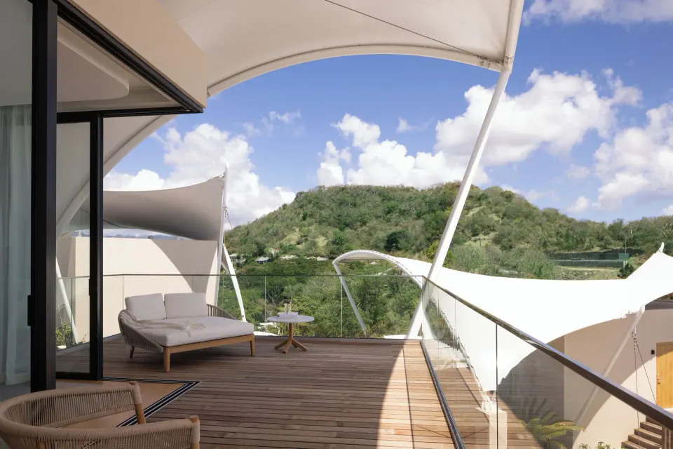 Island View room deck with daybed and hillside outlook at Silversands Beach House Grenada.