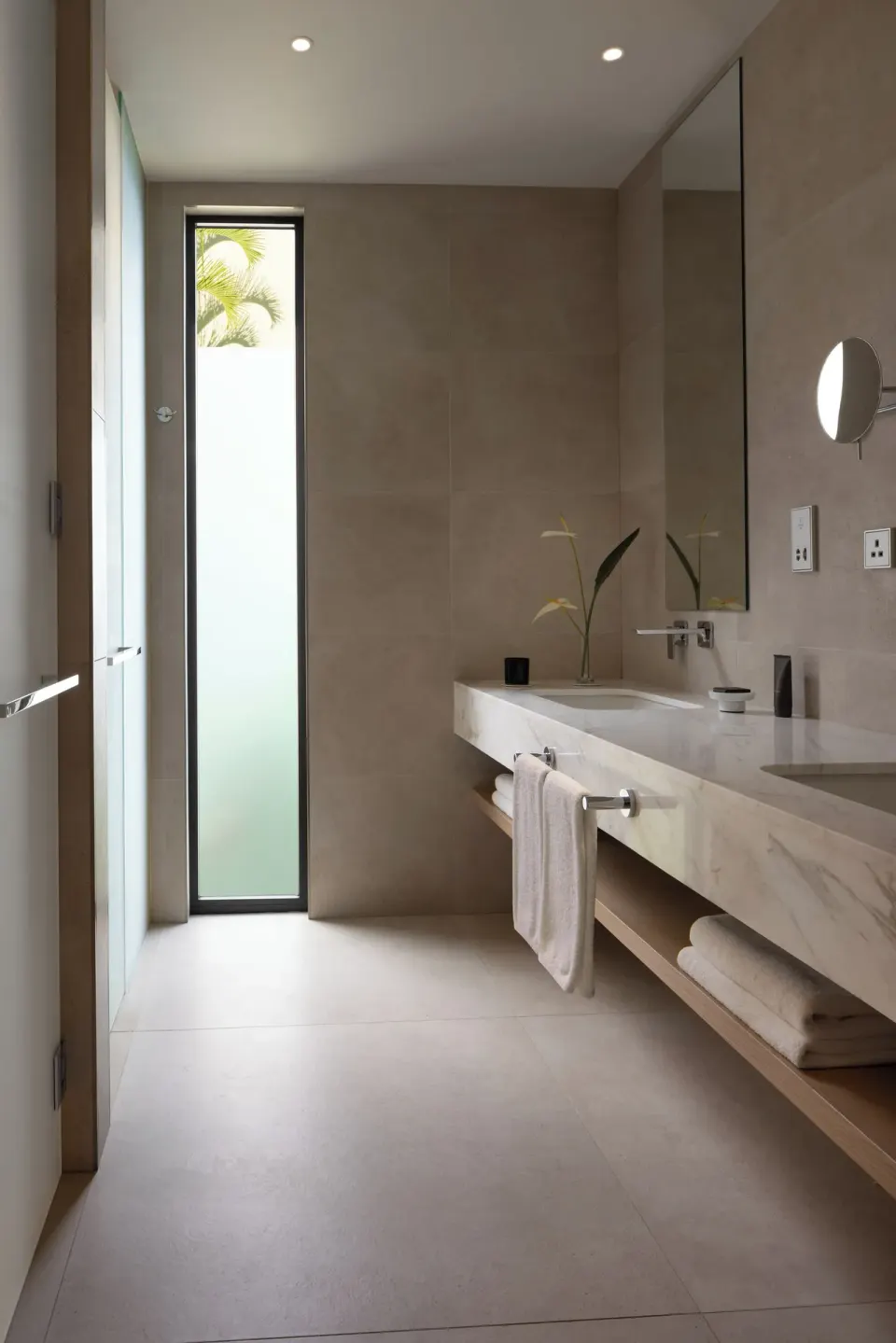 Ocean View room bathroom vanity and tall window at Silversands Beach House Grenada.