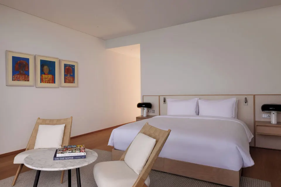 Ocean View room with king bed and lounge chairs at Silversands Beach House Grenada.