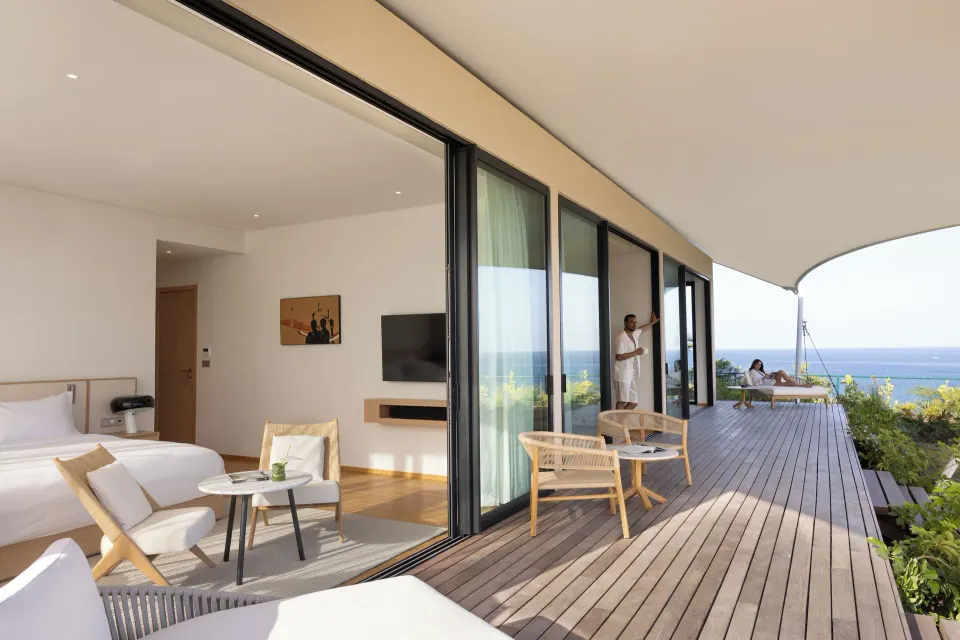 Suite bedroom and long ocean-facing terrace at Silversands Beach House Grenada.