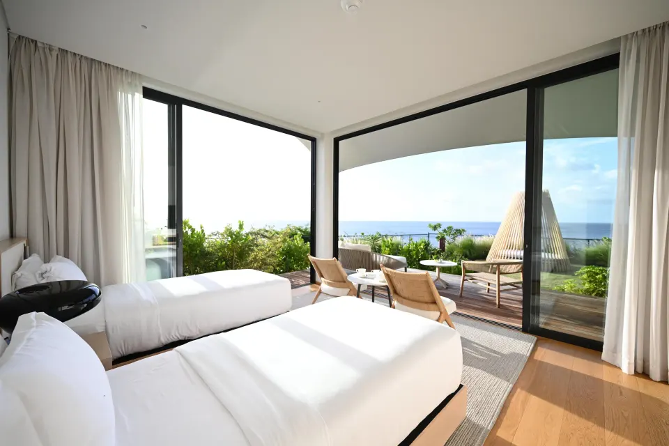 Twin bedroom with terrace and ocean view at Silversands Beach House Grenada.
