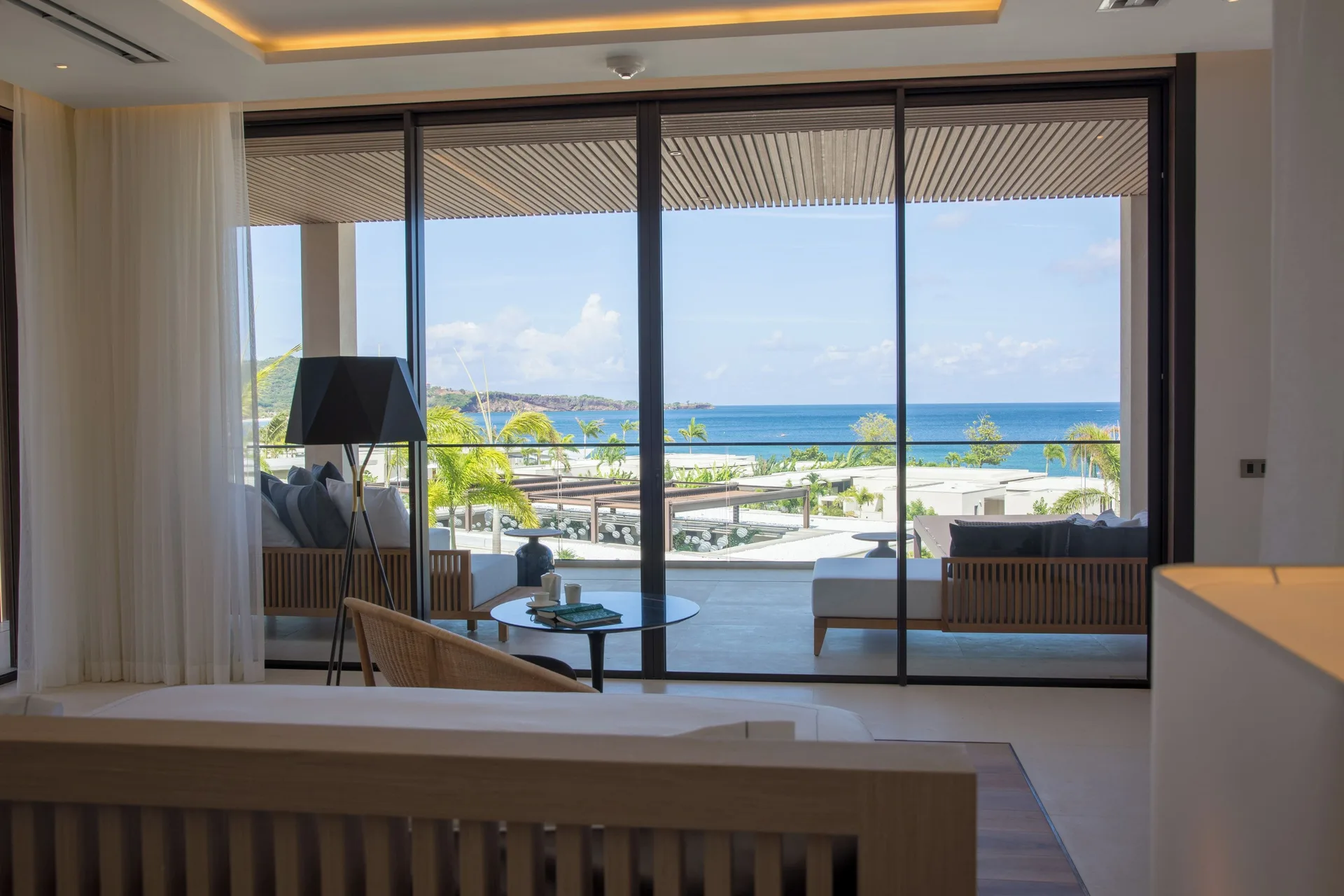 Villa bedroom seating area facing the ocean at Silversands Beach House Grenada.