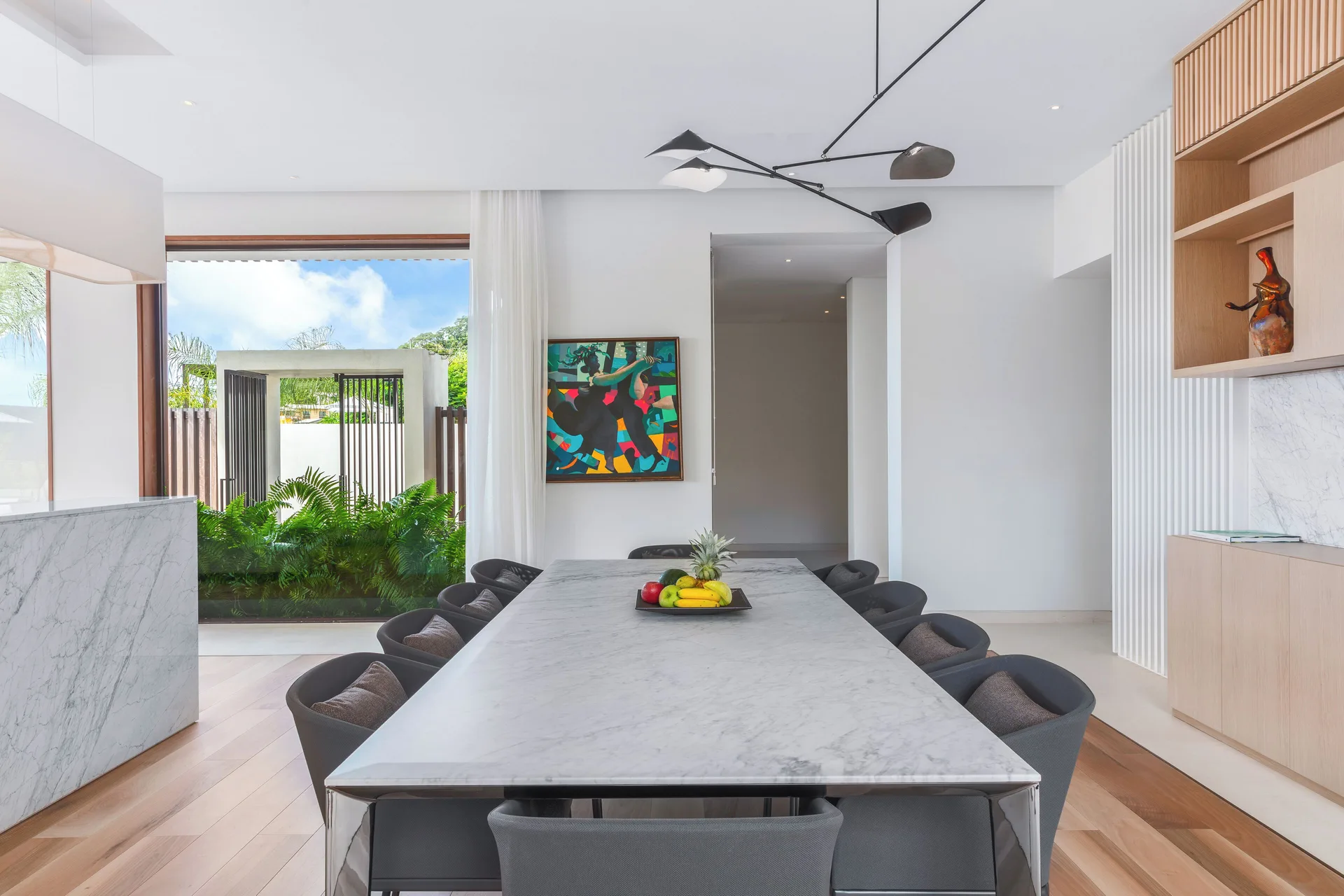 Oceanview villa dining room with long marble table at Silversands Beach House Grenada.