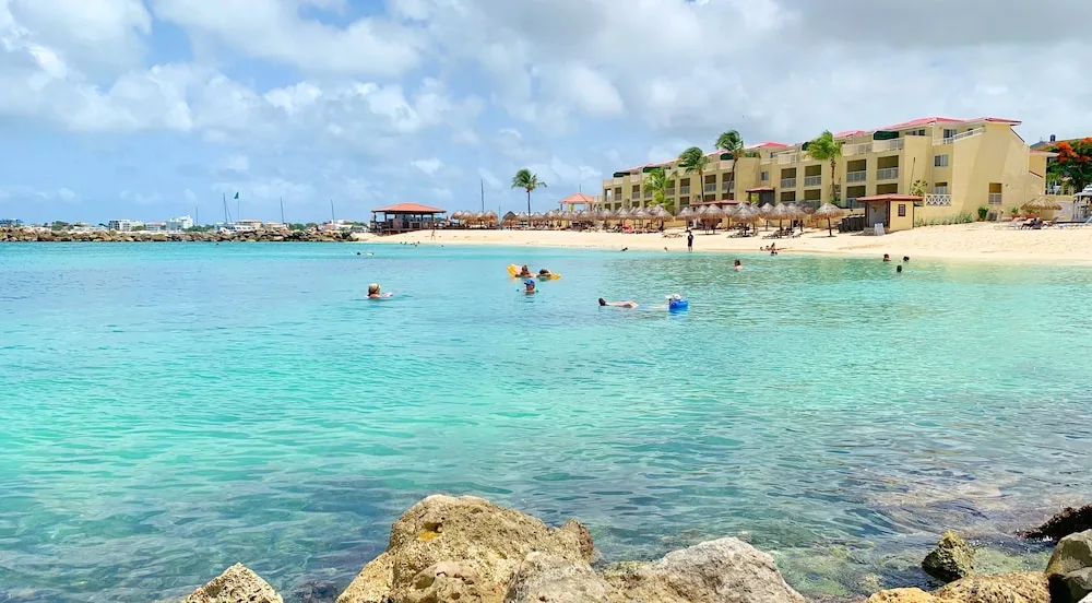 Turquoise beach water and resort buildings at Simpson Bay Resort, Marina & Spa.