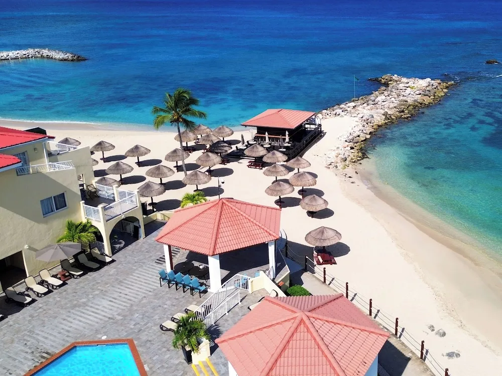 Aerial view of the beach and umbrellas at Simpson Bay Resort, Marina & Spa.