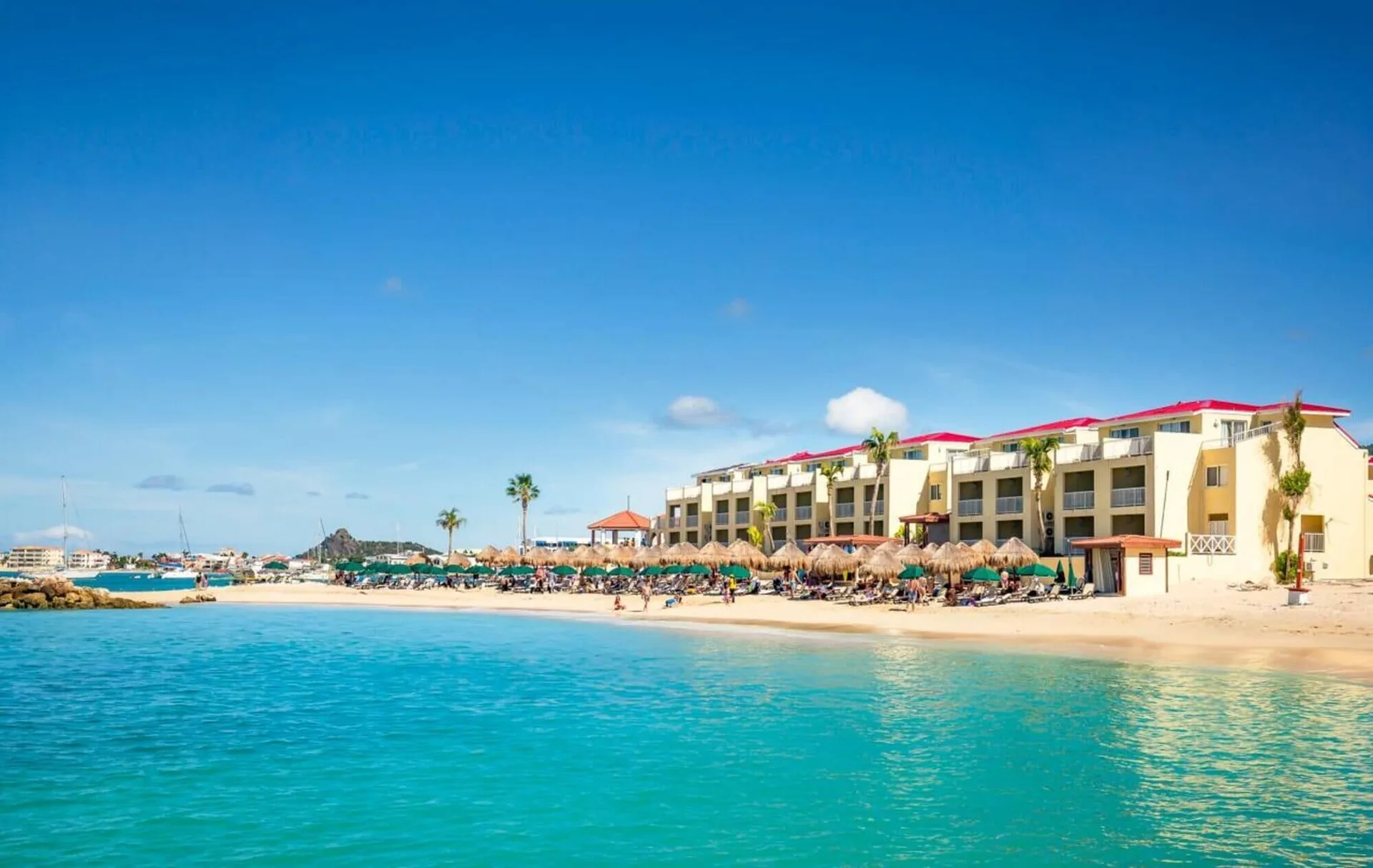 Beachfront resort buildings and turquoise water at Simpson Bay Resort, Marina & Spa.
