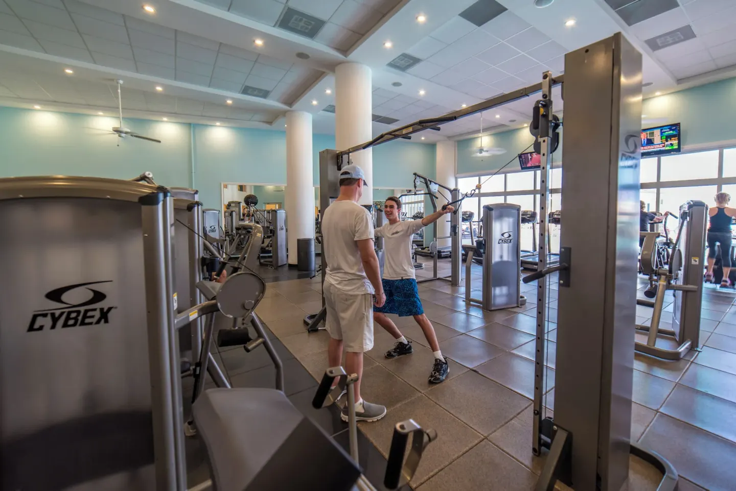 Fitness center with strength machines and guests exercising at Simpson Bay Resort, Marina & Spa.