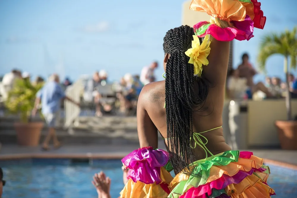 Colorful poolside performer entertaining guests at Simpson Bay Resort, Marina & Spa.