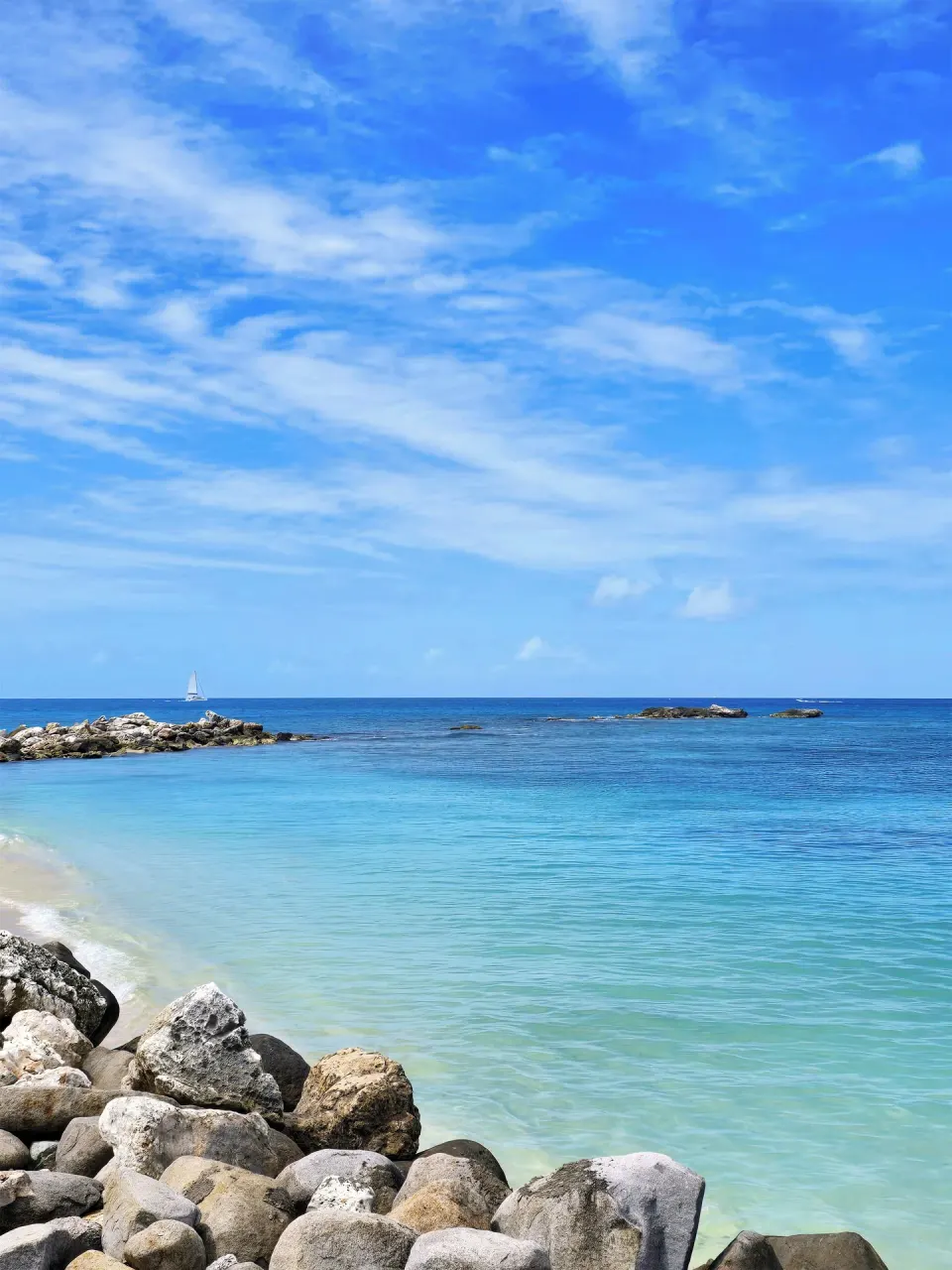 Rocky shoreline and turquoise sea at Simpson Bay Resort, Marina & Spa.