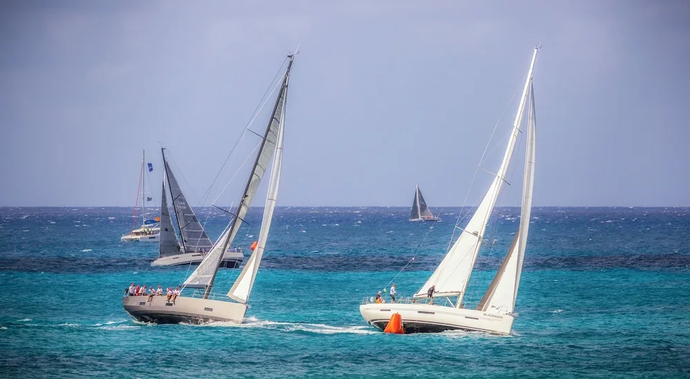 Sailboats race across blue water near Simpson Bay Resort, Marina & Spa.