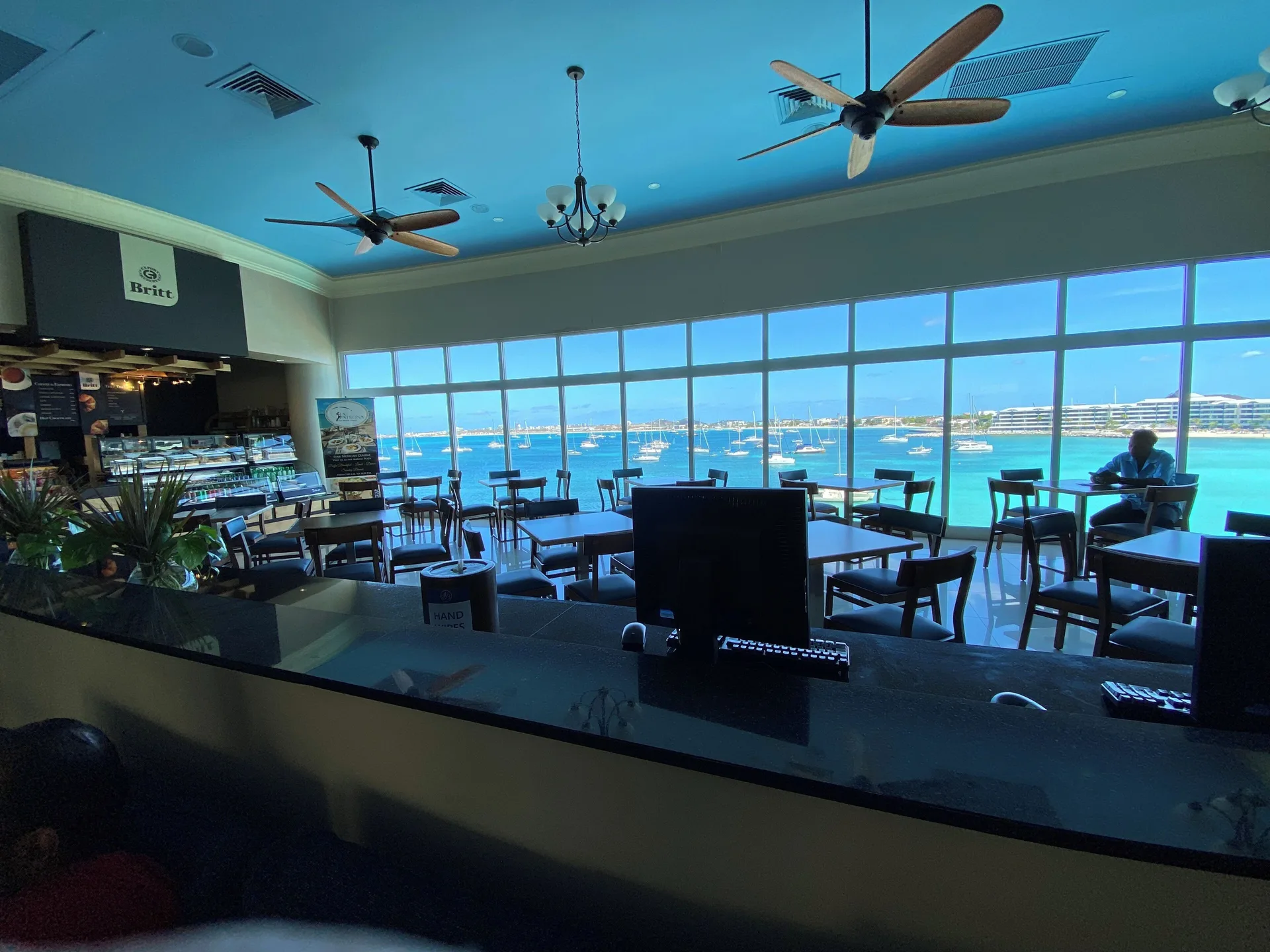 Café seating with large marina-view windows at Simpson Bay Resort, Marina & Spa.