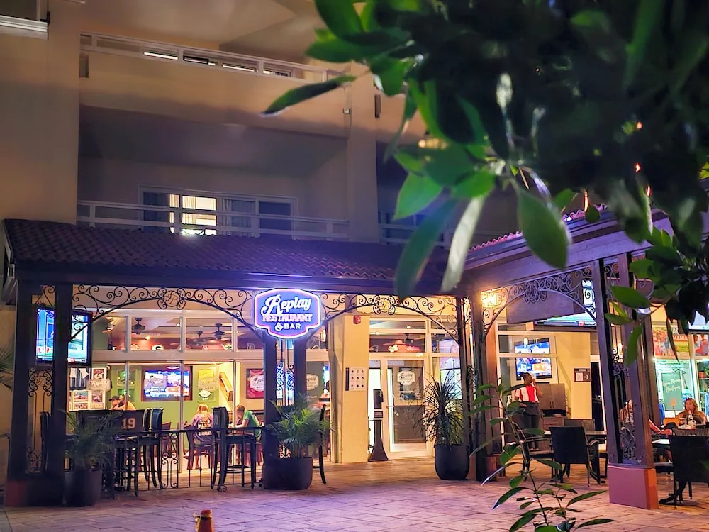 Replay Restaurant & Bar entrance lit at night at Simpson Bay Resort, Marina & Spa.