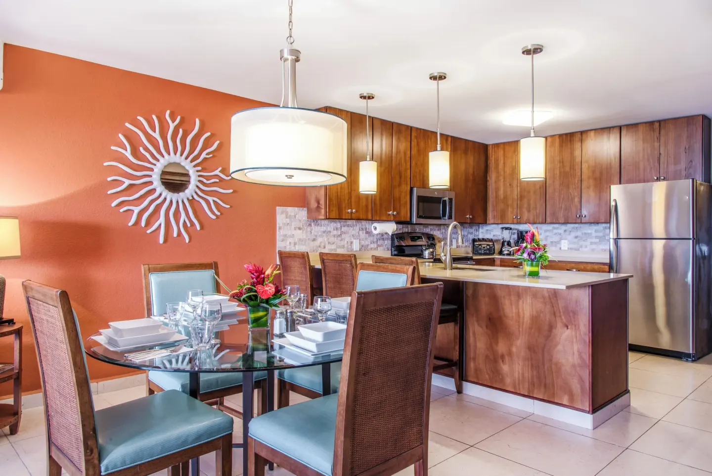 Deluxe Suite kitchen and dining area at Simpson Bay Resort, Marina & Spa with island and set table.