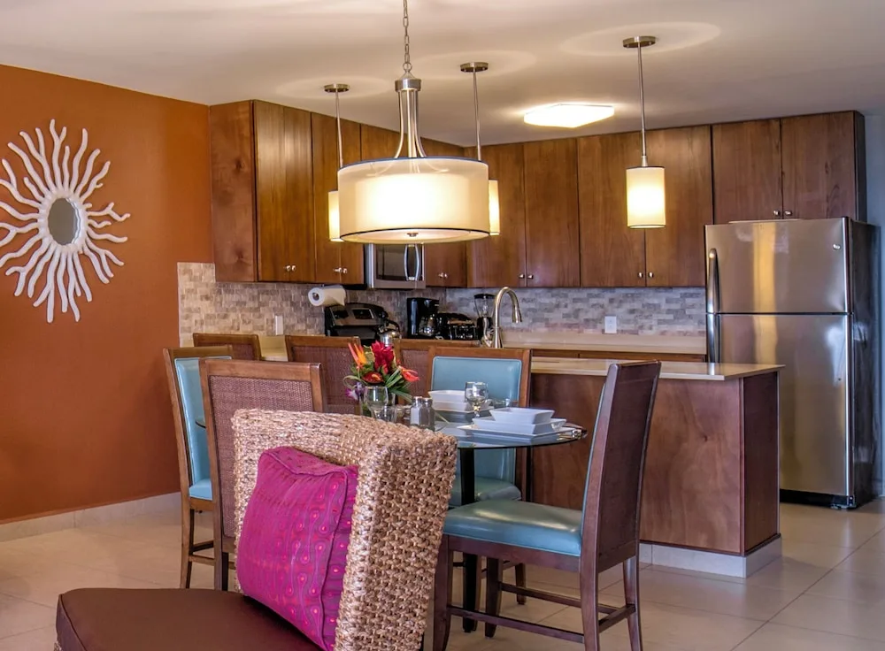 The Resort Three Bedroom Suite at Simpson Bay Resort with spacious living area, full kitchen, and dining space overlooking the marina in Sint Maarten.