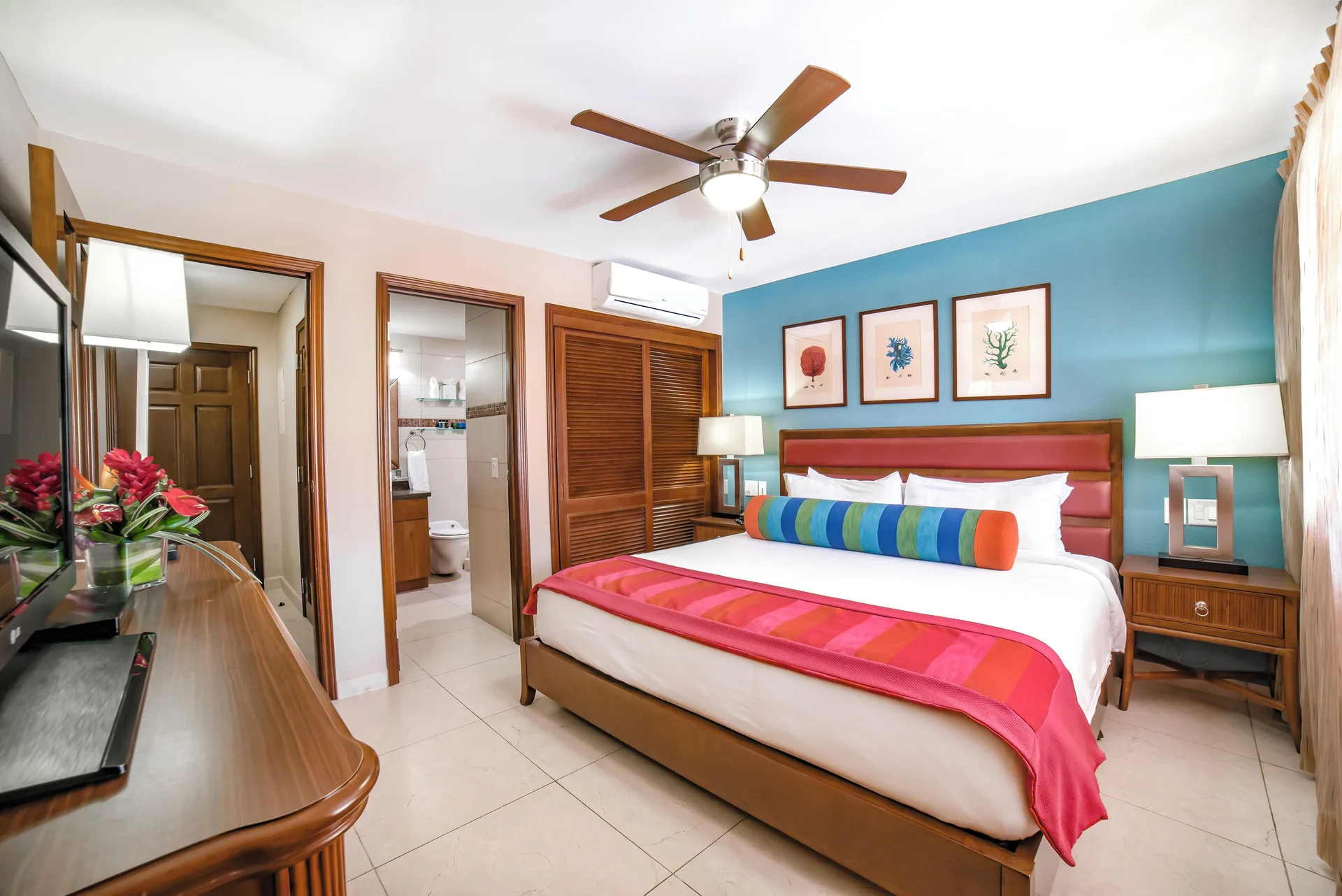 Deluxe Suite bedroom with king bed and bathroom doorway at Simpson Bay Resort, Marina & Spa.