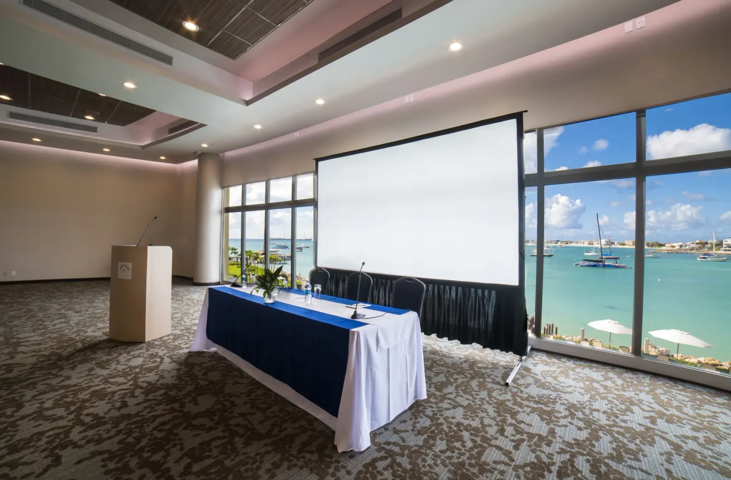 Conference room with projector screen and bay views at Simpson Bay Resort, Marina & Spa.