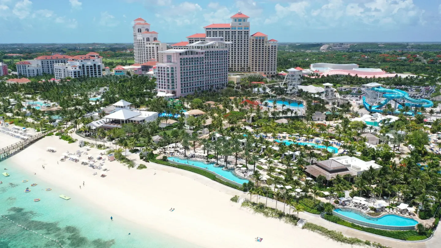 An aerial view shows the beach, pools, water park, and resort towers at SLS Baha Mar.