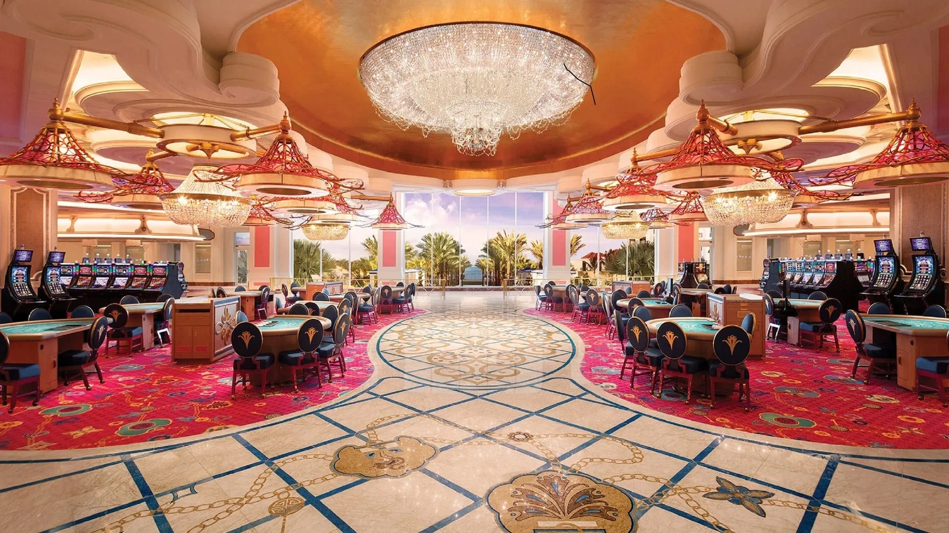 Gaming floor with chandeliers and slot machines near SLS Baha Mar.