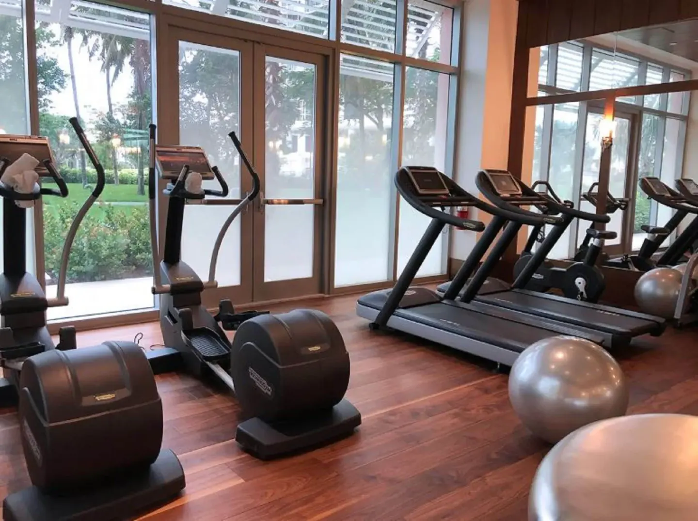 Fitness room with cardio machines and mirrored walls at SLS Baha Mar.