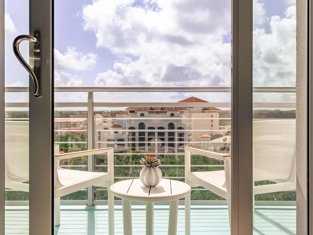 Private balcony with two chairs and a resort building view at SLS Baha Mar.