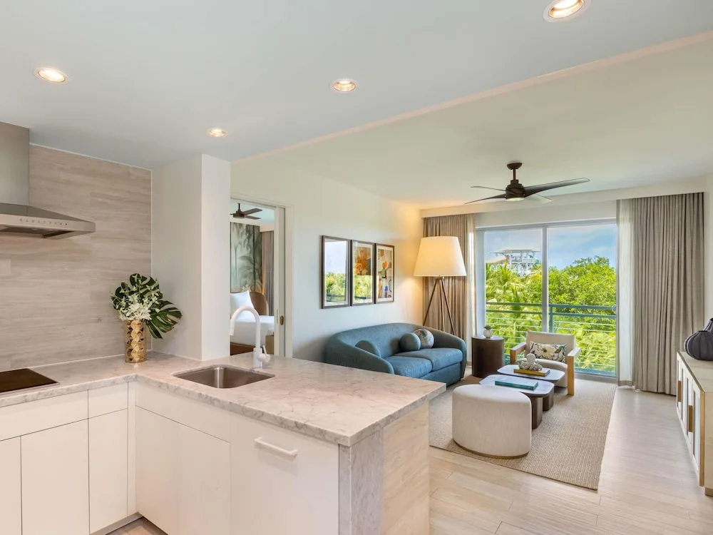 Suite kitchen and sitting area with balcony greenery views at SLS Baha Mar.