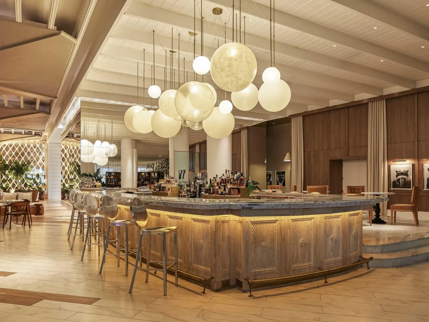 Lobby bar with globe pendant lights and bar stools at SLS Baha Mar.