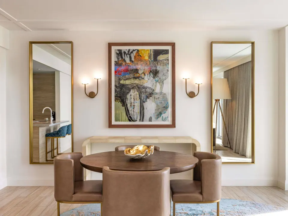 Ocean View One Bedroom Residence dining nook at SLS Baha Mar with mirrors and wall art.