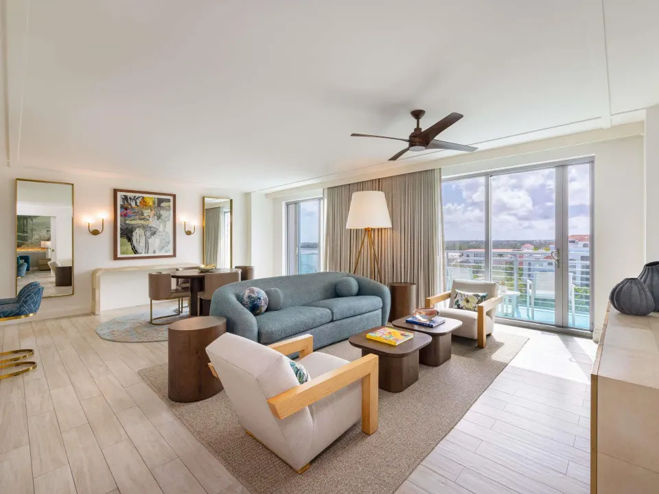 Ocean View One Bedroom Residence sitting area at SLS Baha Mar with sofa and balcony windows.