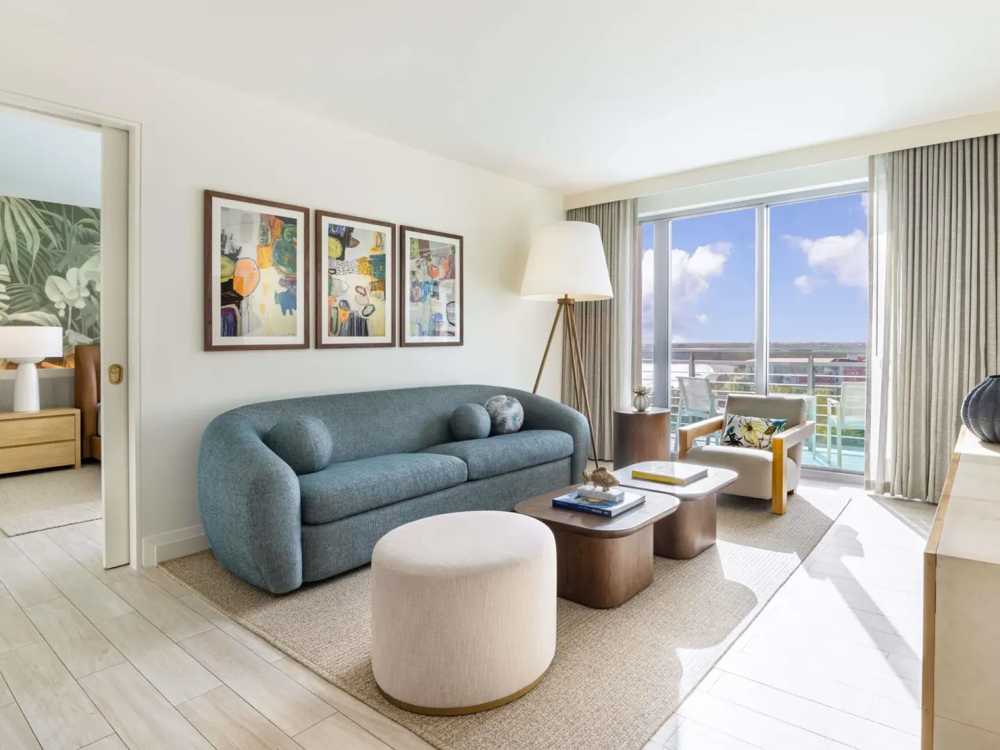 Ocean View Signature Suite living room with balcony doors at SLS Baha Mar.