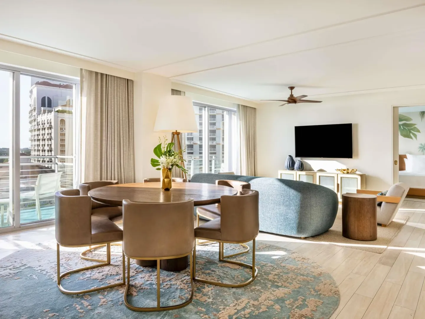 Ocean View Two Bedroom Residence dining and living area with balcony at SLS Baha Mar.