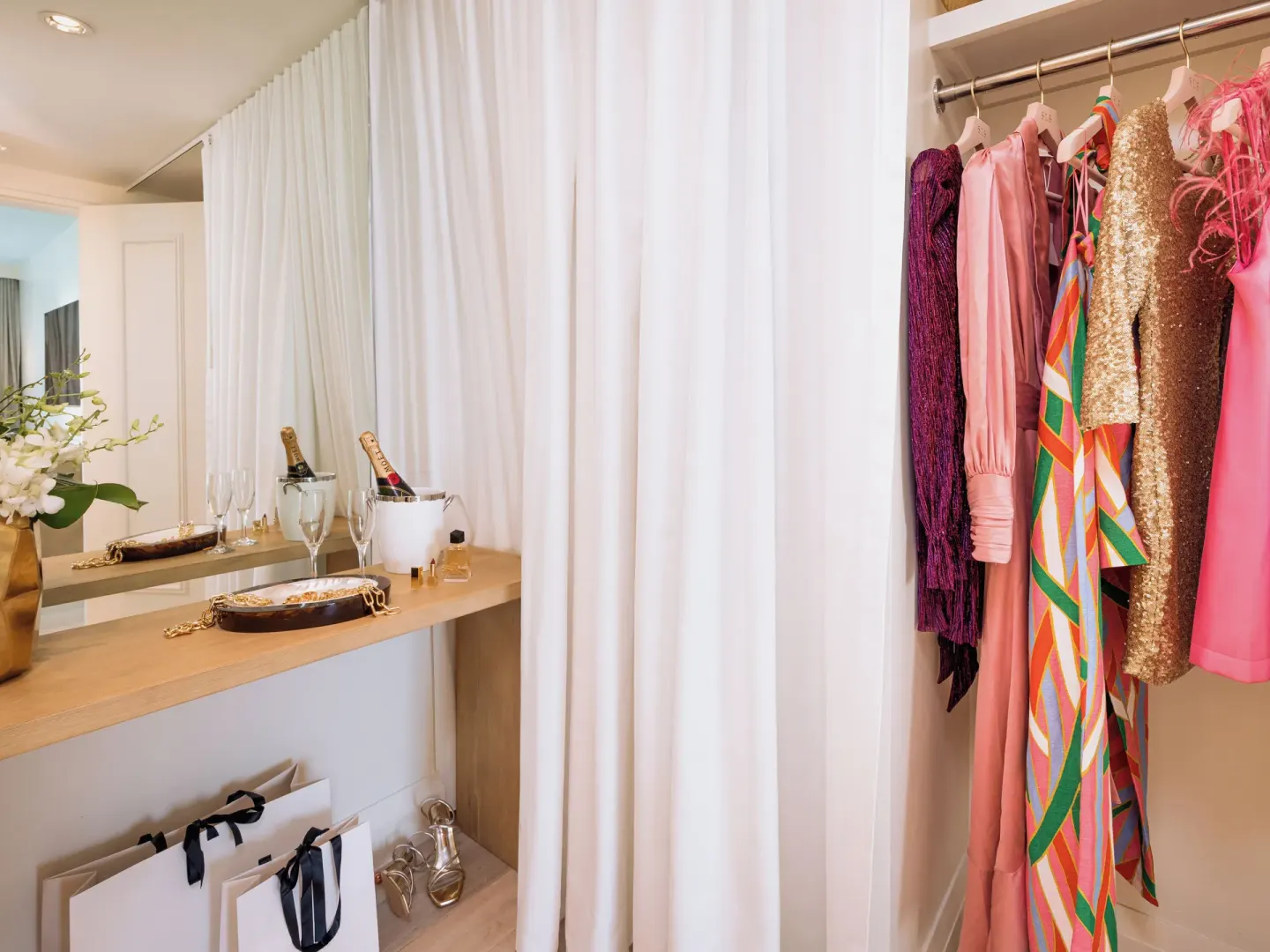 Ocean View Two Bedroom Residence dressing closet with colorful clothing at SLS Baha Mar.
