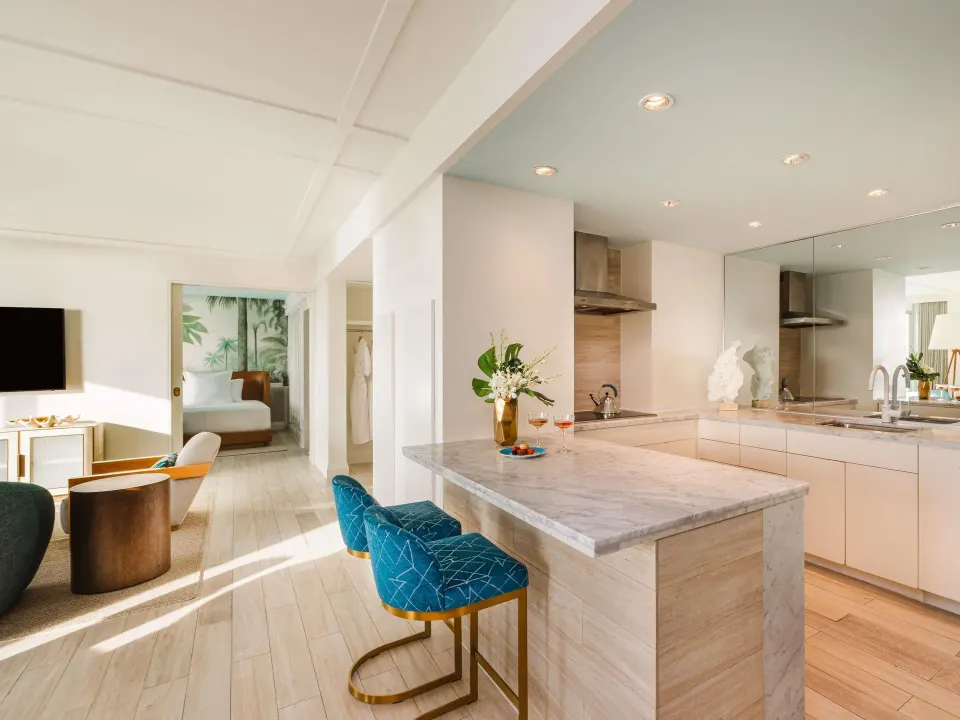 Ocean View Two Bedroom Residence kitchen and lounge with bedroom beyond at SLS Baha Mar.