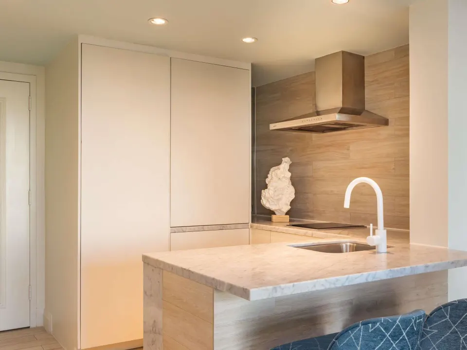 Kitchenette in an Ocean View Two Bedroom Suite at SLS Baha Mar with marble counter and cooktop.