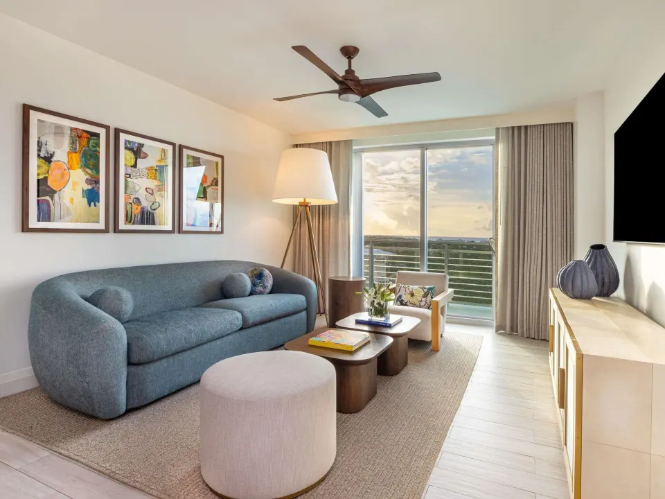 Living room in an Ocean View Two Bedroom Suite at SLS Baha Mar with sofa, balcony, and ocean view.