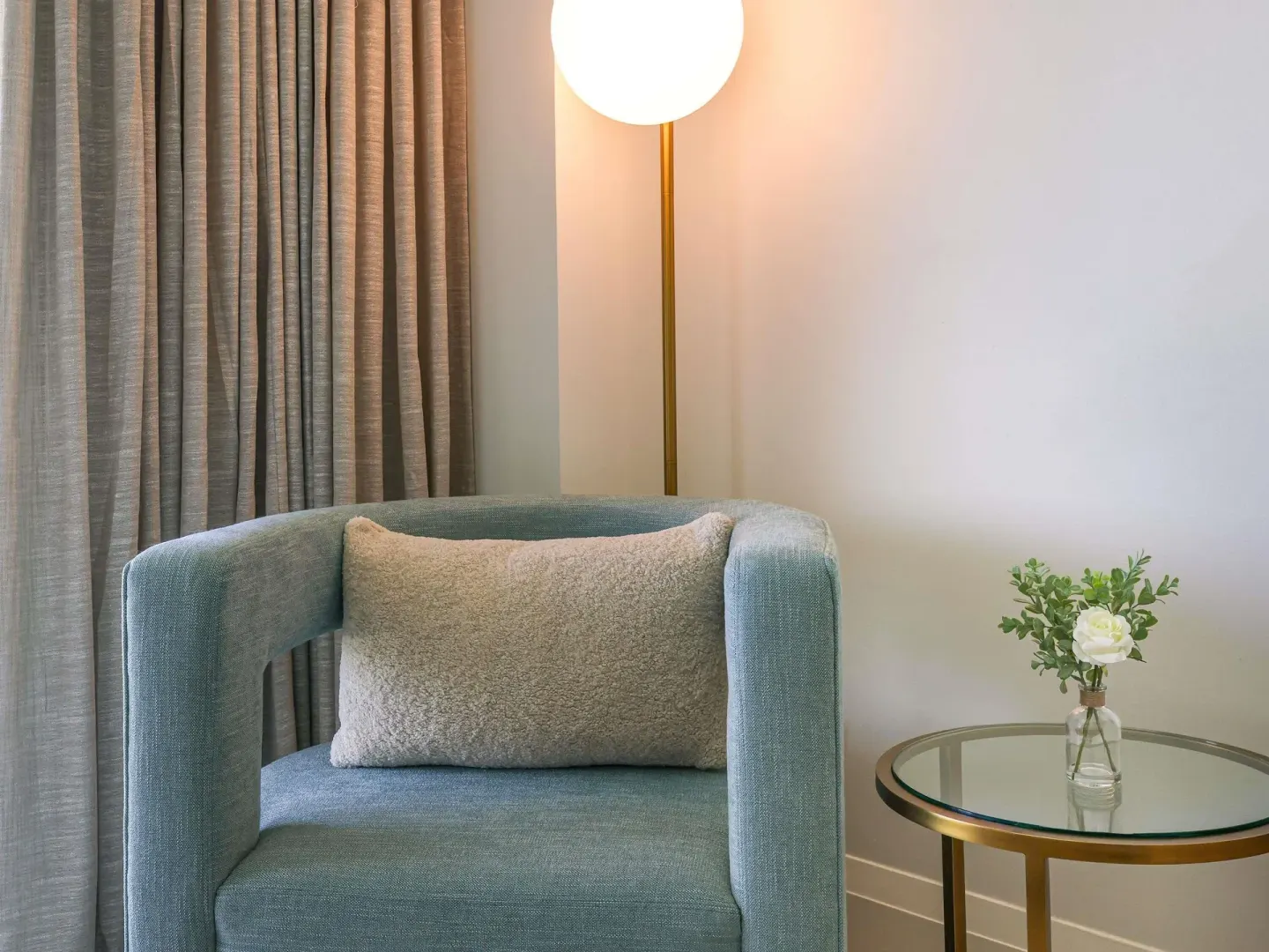 Superior Queens sitting corner with blue chair, side table, and lamp at SLS Baha Mar.