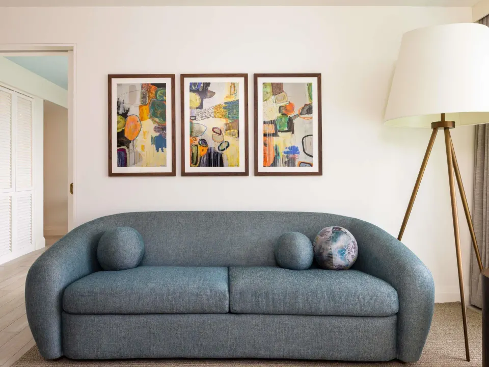 Superior Suite sofa wall with abstract art and floor lamp at SLS Baha Mar.