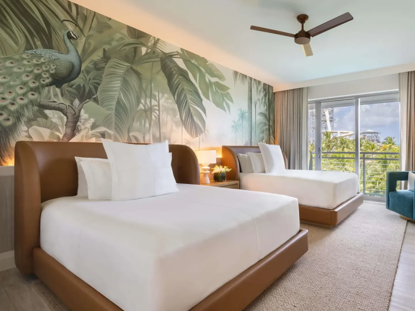 Two white beds in a Superior Two Bedroom Suite guest room at SLS Baha Mar.