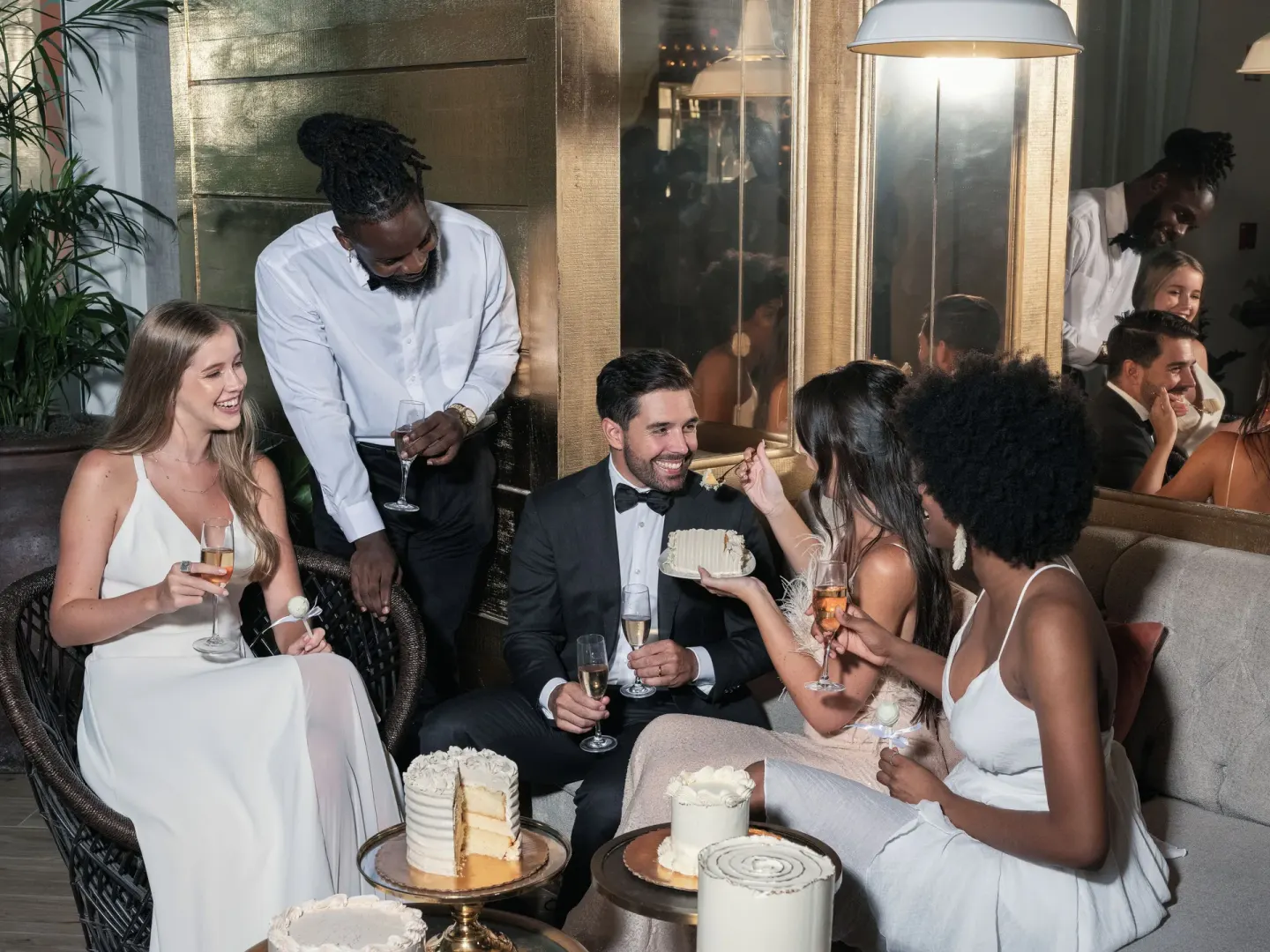 Guests in formalwear sharing cake and champagne at SLS Baha Mar.