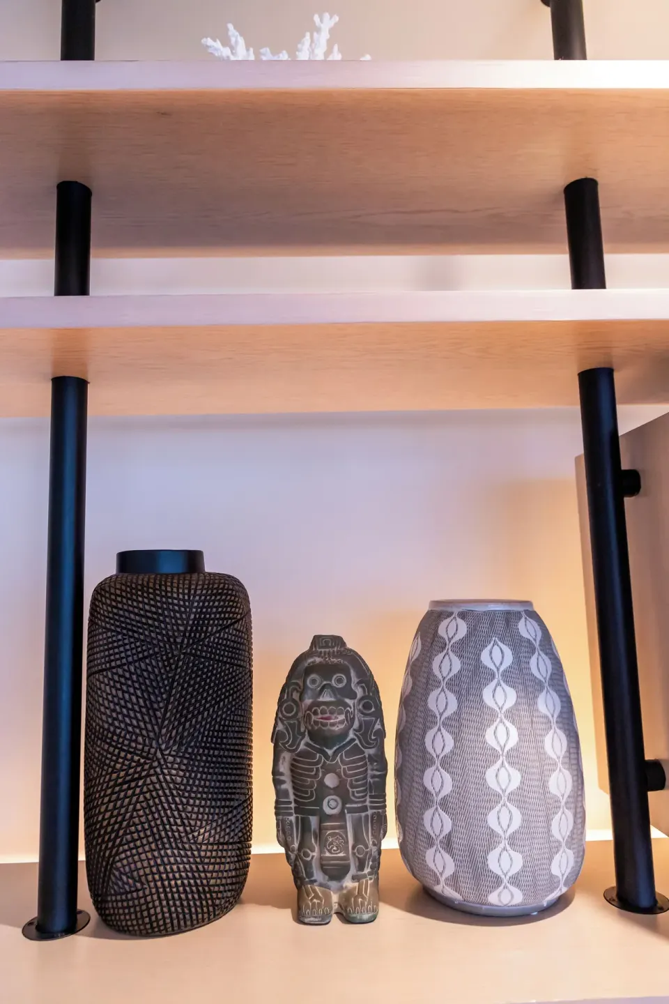 Decorative vases and sculpture displayed on open shelves at SLS Cancun.