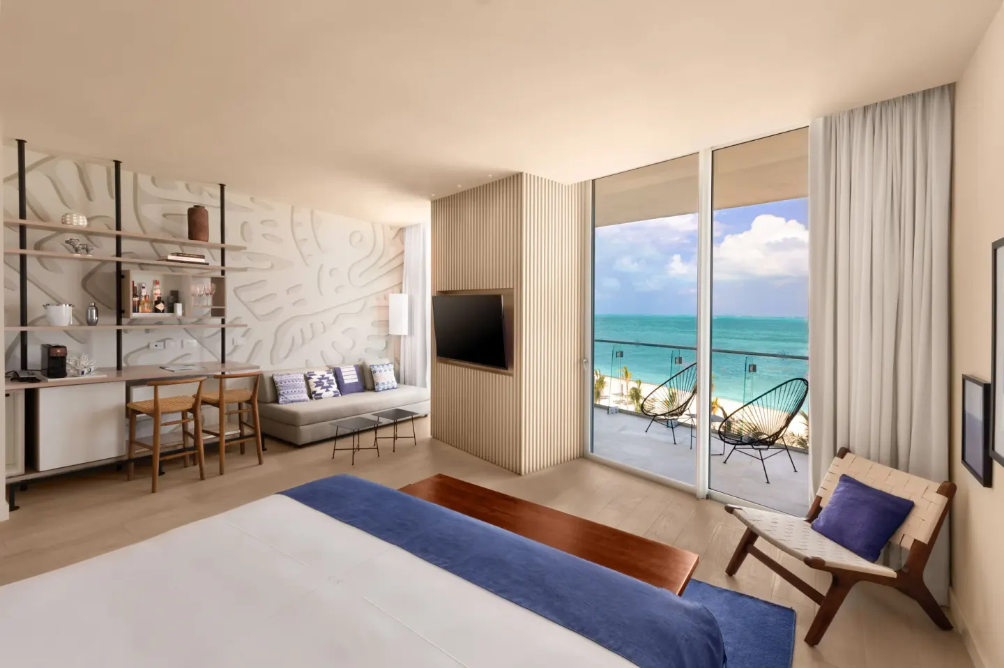 Deluxe Room Oceanfront at SLS Cancun with king bed, seating area, balcony and Caribbean view.