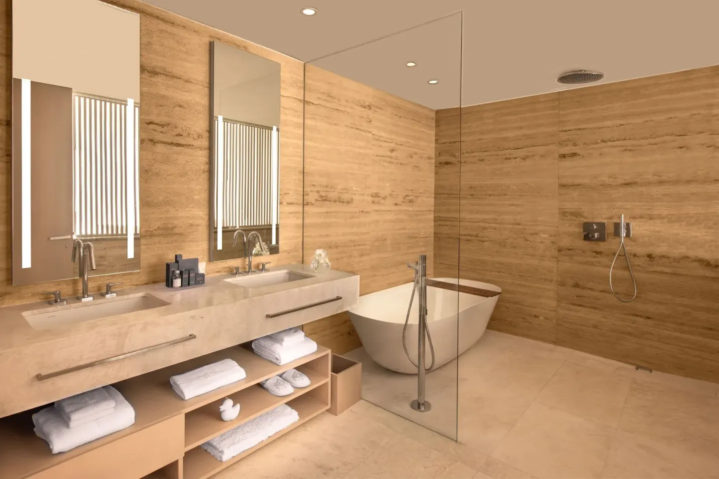Premier Suite bathroom with double vanity, soaking tub, and glass shower at SLS Cancun.