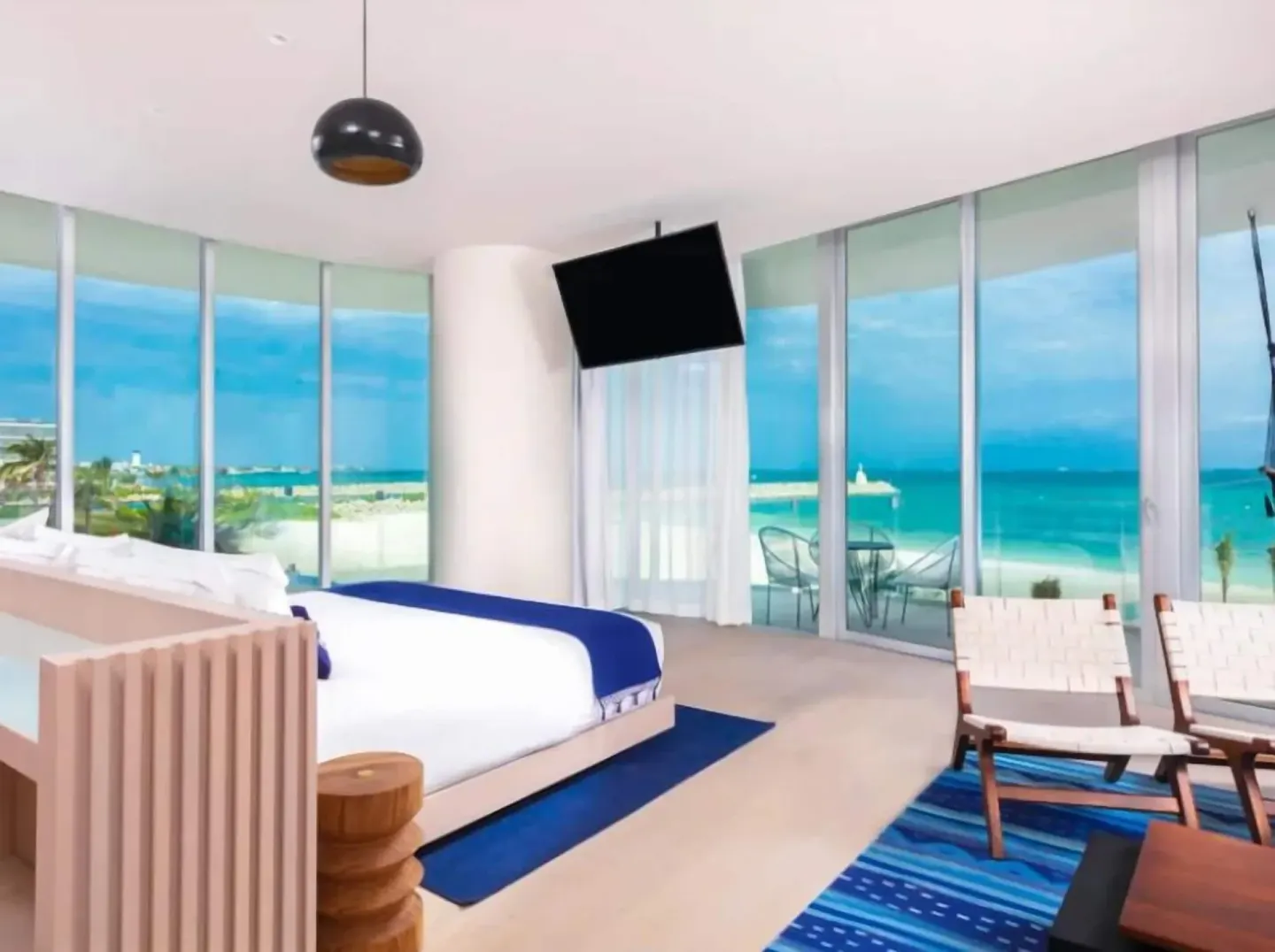 Premier Suite king bed with floor-to-ceiling oceanfront windows at SLS Cancun.