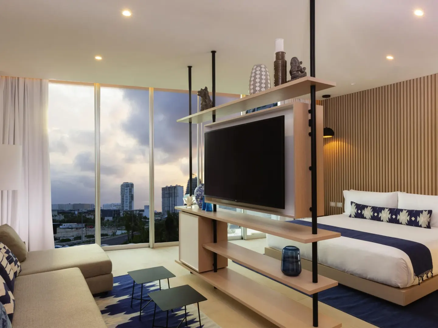 Superior Room with king bed, sofa, TV shelving, and floor-to-ceiling windows at SLS Cancun.